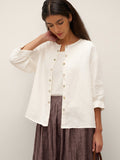 Blusa de lino puro con mangas abullonadas y espalda plisada