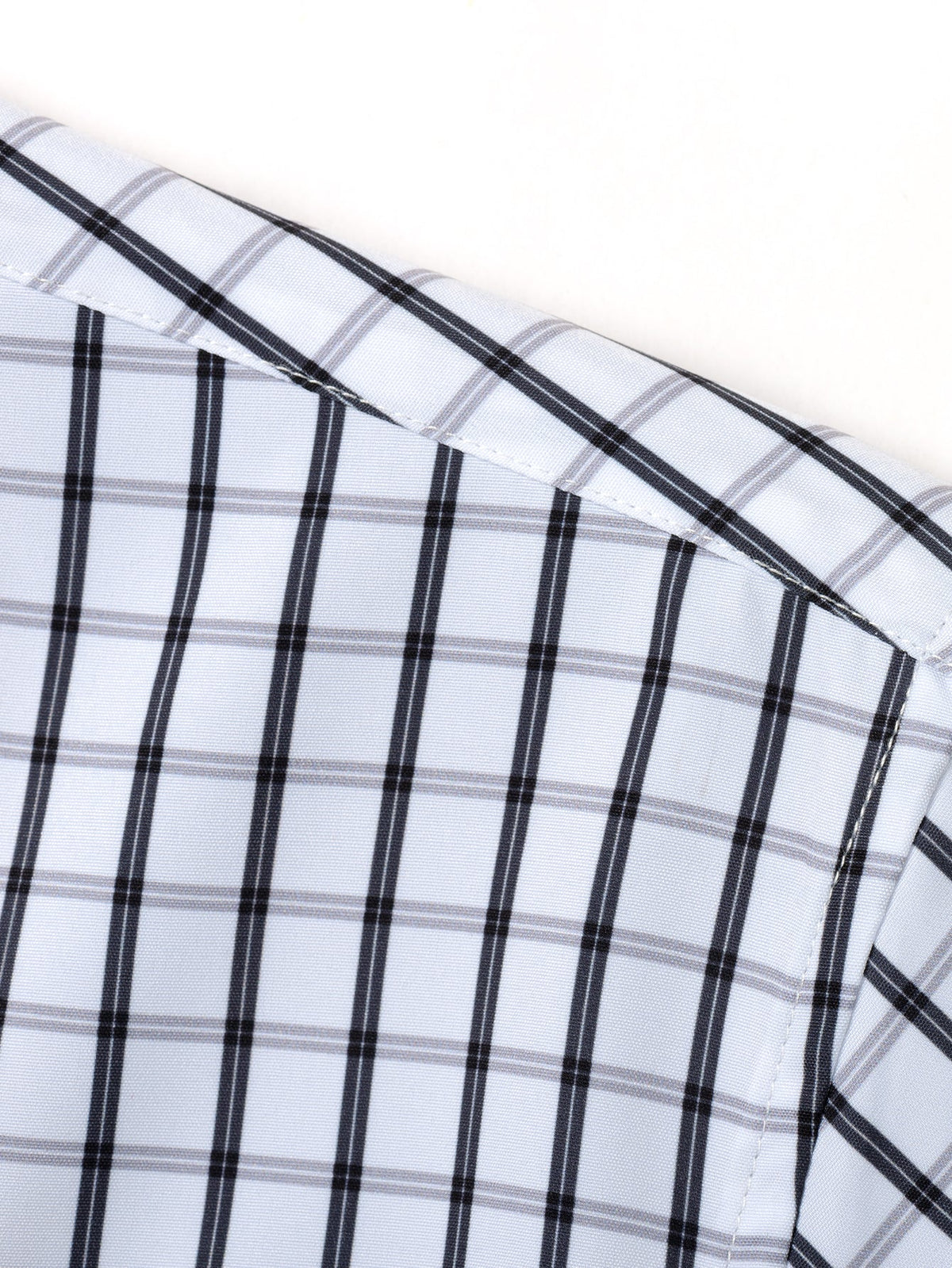 Long-sleeved plaid button-down shirt and tapered slim-fit trousers