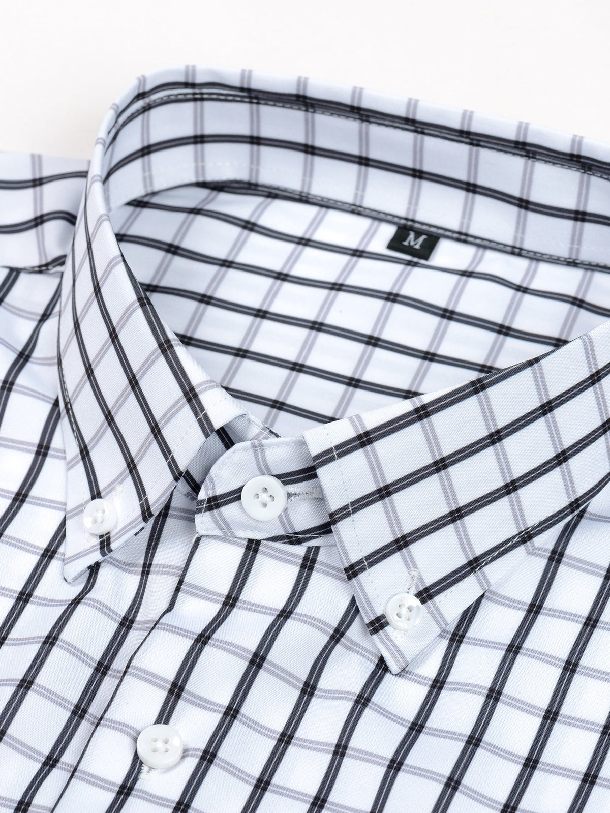 Long-sleeved plaid button-down shirt and tapered slim-fit trousers